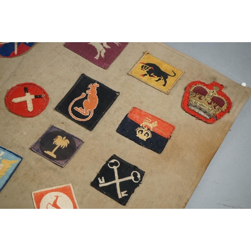 433 - A Collection Of Approx Twenty Five British Military Cloth Badges, Sewn To Cloth And Mounted On Board... 