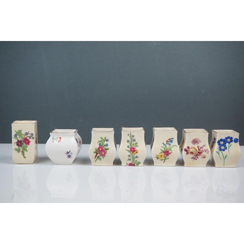 303 - A collection of seven Royal Doulton miniature porcelain floral vases.