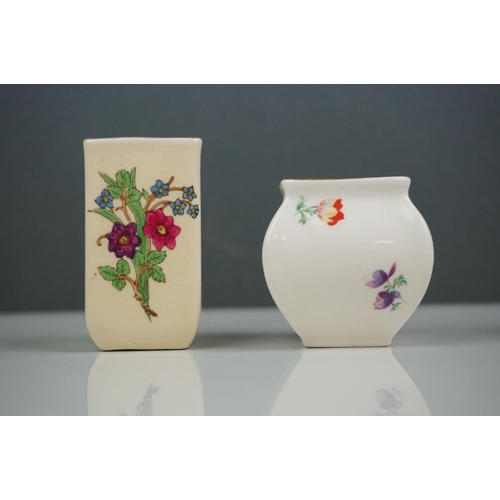 303 - A collection of seven Royal Doulton miniature porcelain floral vases.