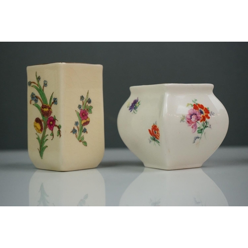 303 - A collection of seven Royal Doulton miniature porcelain floral vases.