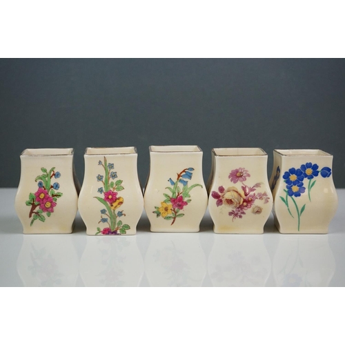 303 - A collection of seven Royal Doulton miniature porcelain floral vases.