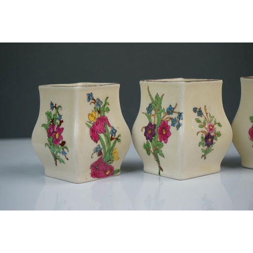 303 - A collection of seven Royal Doulton miniature porcelain floral vases.