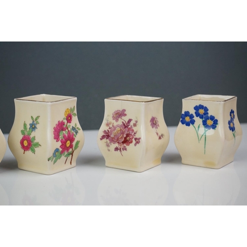 303 - A collection of seven Royal Doulton miniature porcelain floral vases.