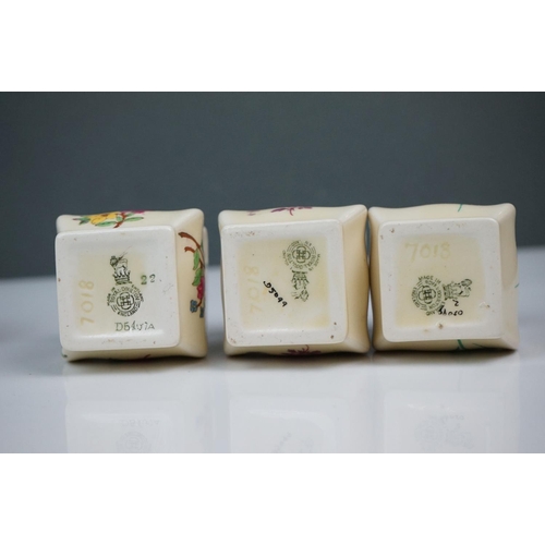 303 - A collection of seven Royal Doulton miniature porcelain floral vases.