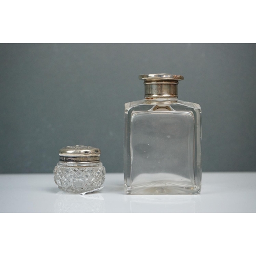 315 - A collection of vintage silver topped scent bottles to include hallmarked examples.