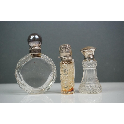 315 - A collection of vintage silver topped scent bottles to include hallmarked examples.