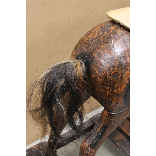43 - Wooden Rocking Horse raised on a bow rocker, 124cms long x 85cms high
