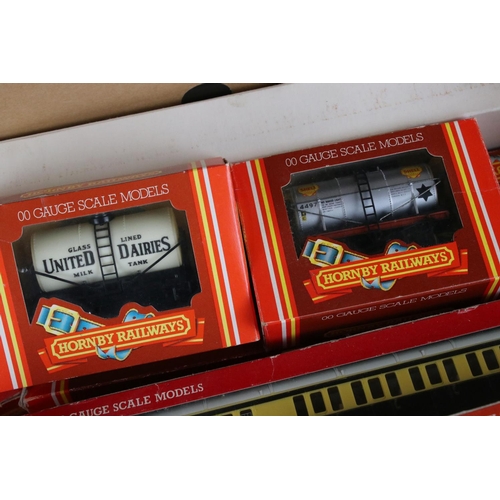 136 - 28 boxed Hornby OO gauge items of rolling stock to include coaches and wagons featuring R427, R895, ... 