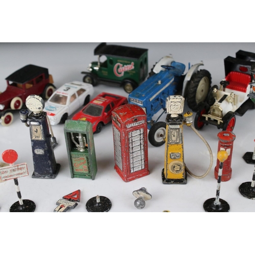 462 - Collection of various mid 20th C play worn metal roadside accessories to include petrol pumps, traff... 