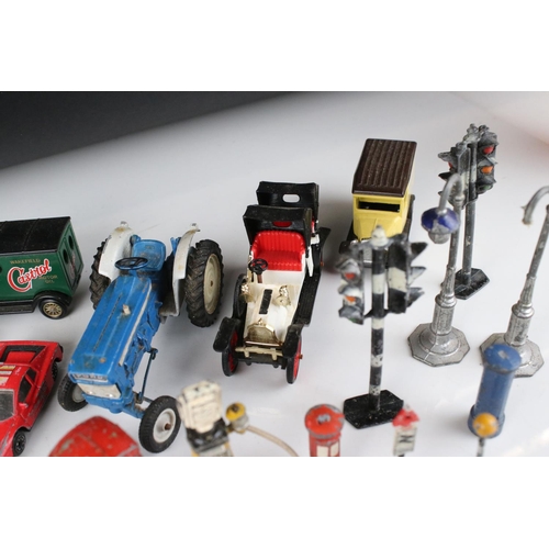 462 - Collection of various mid 20th C play worn metal roadside accessories to include petrol pumps, traff... 