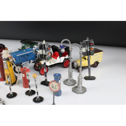 462 - Collection of various mid 20th C play worn metal roadside accessories to include petrol pumps, traff... 