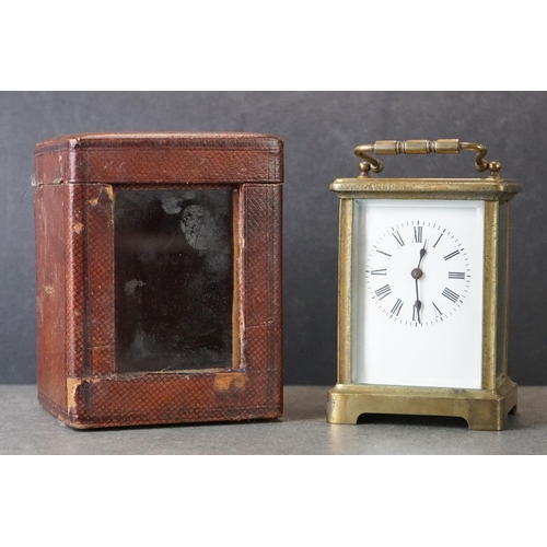 185 - An early 20th century brass cased carriage clock, complete with travel case and key.