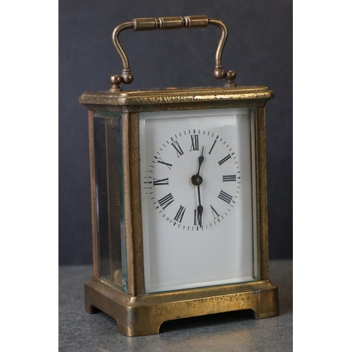 185 - An early 20th century brass cased carriage clock, complete with travel case and key.