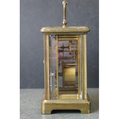 185 - An early 20th century brass cased carriage clock, complete with travel case and key.