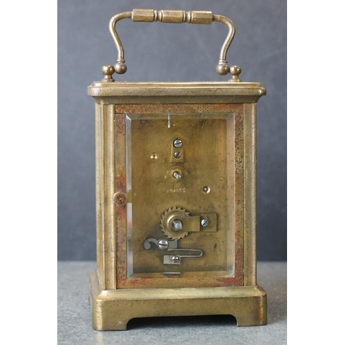 185 - An early 20th century brass cased carriage clock, complete with travel case and key.