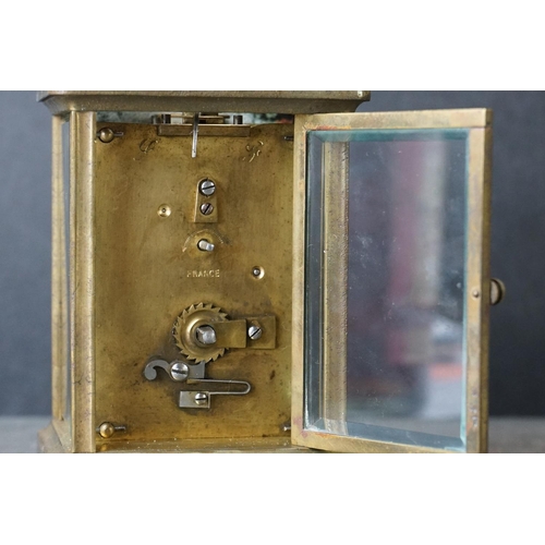 185 - An early 20th century brass cased carriage clock, complete with travel case and key.