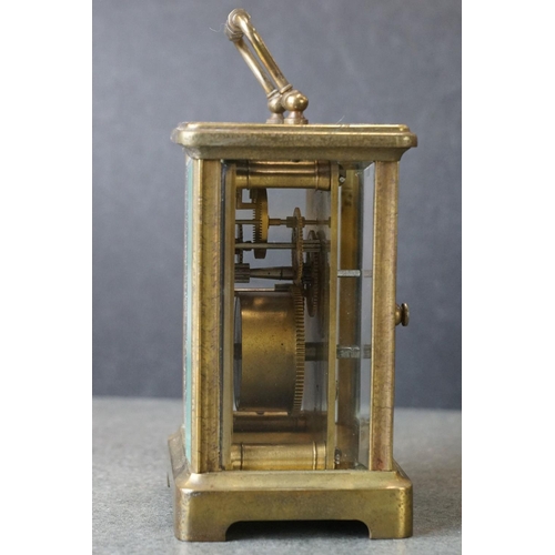 185 - An early 20th century brass cased carriage clock, complete with travel case and key.