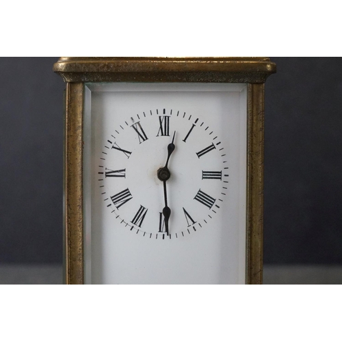 185 - An early 20th century brass cased carriage clock, complete with travel case and key.