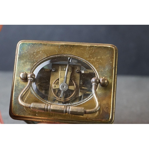 185 - An early 20th century brass cased carriage clock, complete with travel case and key.
