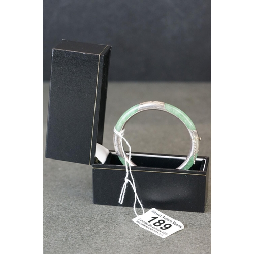 189 - A 925 silver mounted jade bangle.