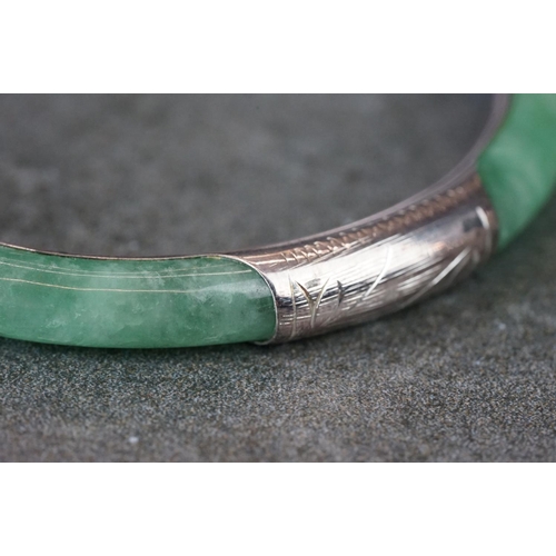 189 - A 925 silver mounted jade bangle.