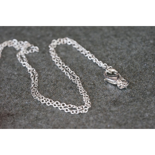 191 - Silver cross necklace with embossed skull decoration