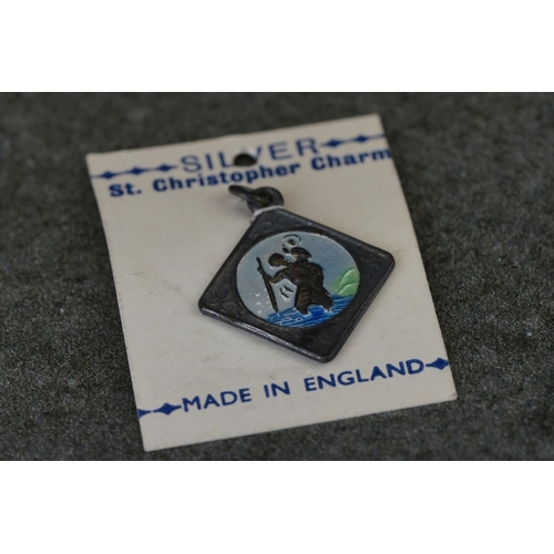 208 - A white metal German St. Christopher plaque together with a silver St. Christopher charm.
