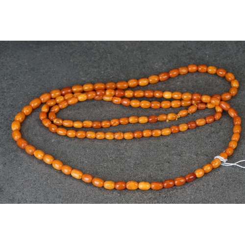209 - A hand strung amber beaded flapper necklace.