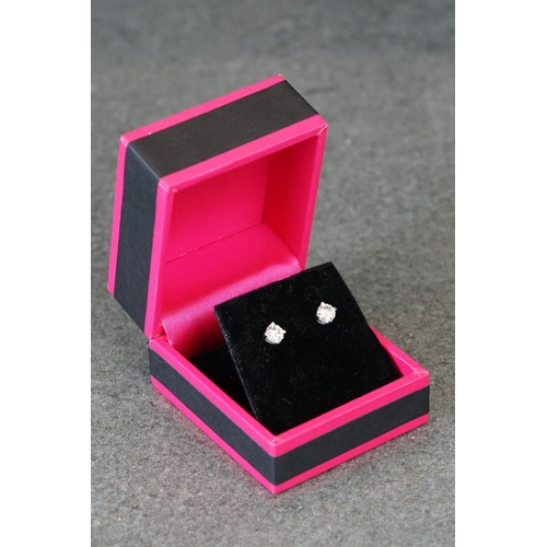 211 - Pair of 14ct white gold diamond stud earrings of 75 points total weight