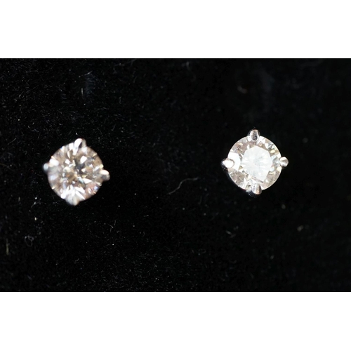 211 - Pair of 14ct white gold diamond stud earrings of 75 points total weight