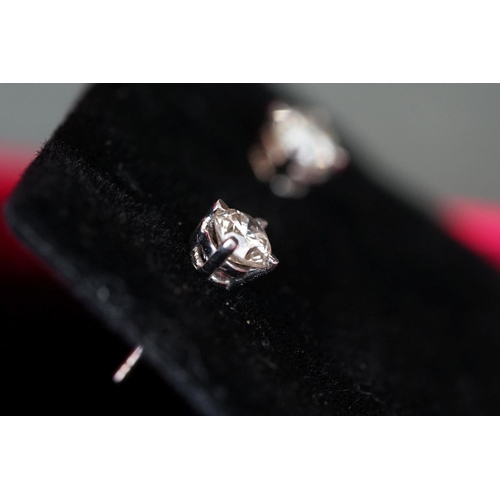 211 - Pair of 14ct white gold diamond stud earrings of 75 points total weight