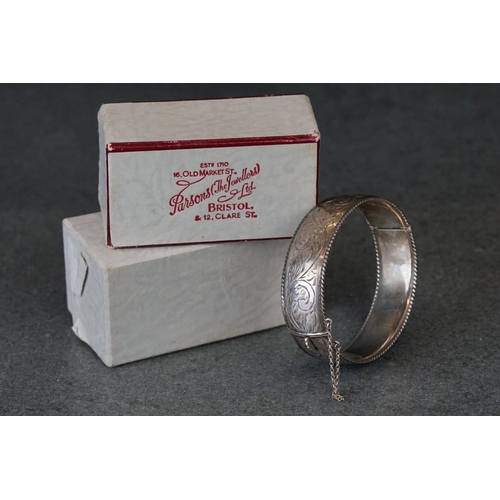 215 - A fully hallmarked sterling silver cuff bangle with engraved decoration.