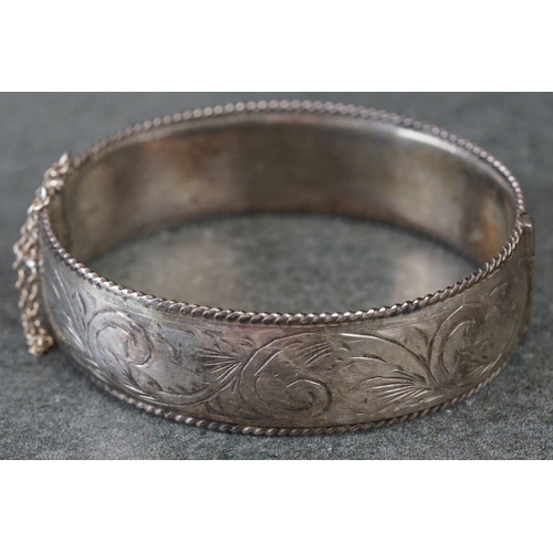 215 - A fully hallmarked sterling silver cuff bangle with engraved decoration.