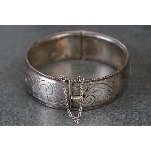 215 - A fully hallmarked sterling silver cuff bangle with engraved decoration.