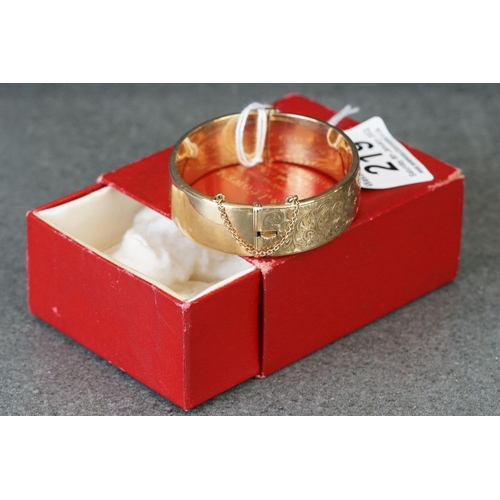 219 - 9ct gold ladies cuff bangle with engraved decoration.