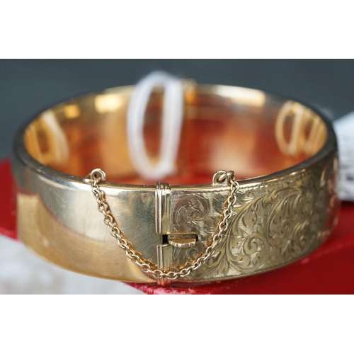 219 - 9ct gold ladies cuff bangle with engraved decoration.