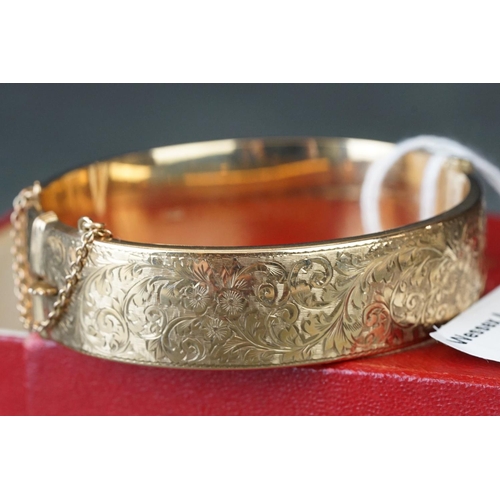 219 - 9ct gold ladies cuff bangle with engraved decoration.