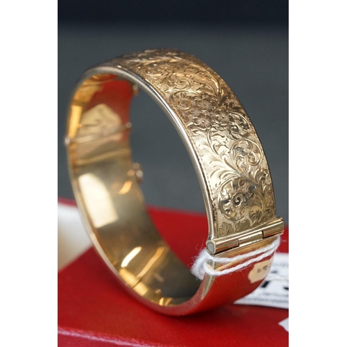 219 - 9ct gold ladies cuff bangle with engraved decoration.