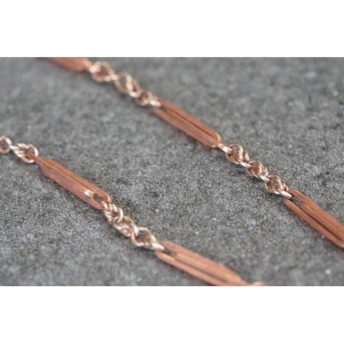 231 - A collection of yellow gold jewellery to include necklace, bracelet, brooch and Albert chain.