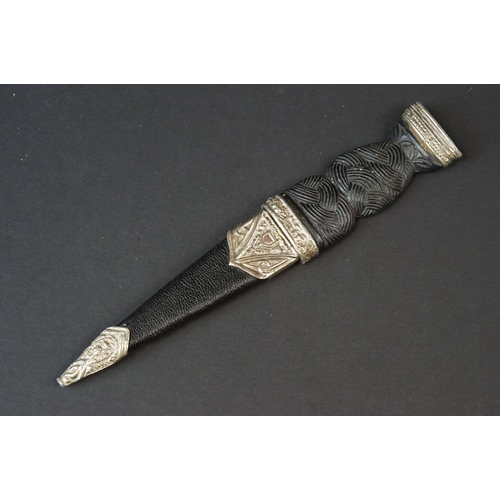 81 - A Scottish Sgian-Dubh Dagger With Fitted Sheath With Thistle Decoration To White Metal.