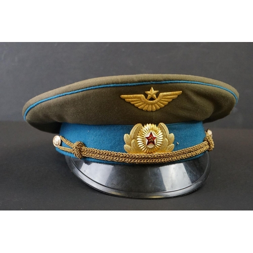 422 - A Russian Military Officers Peak Cap Complete With Badges, Size 57.