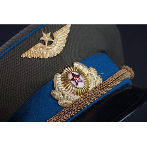 422 - A Russian Military Officers Peak Cap Complete With Badges, Size 57.