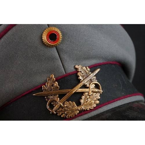 425 - A East German Military Officers Cap With Crossed Swords And laurel Cap Badge.