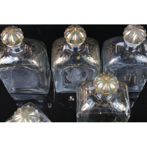 25 - Five Spanish Glass Liquor Decanters and stoppers with gilt decorations marked to base Jerez, Spain, ... 