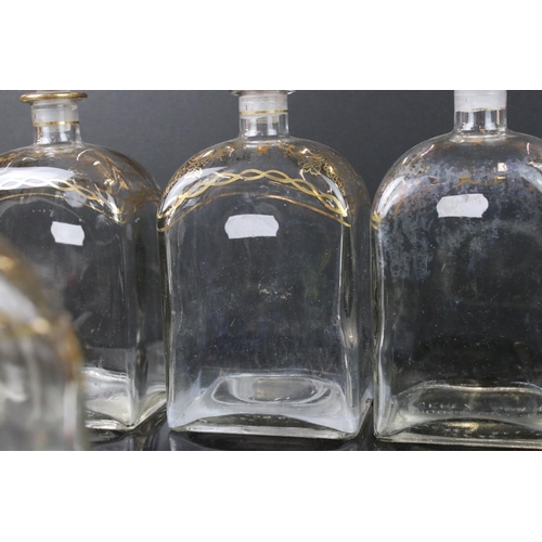 25 - Five Spanish Glass Liquor Decanters and stoppers with gilt decorations marked to base Jerez, Spain, ... 
