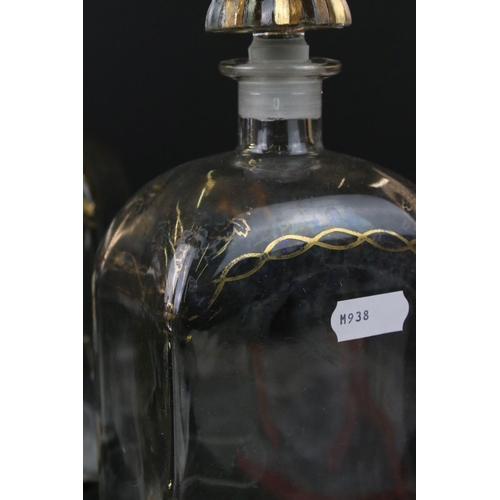 25 - Five Spanish Glass Liquor Decanters and stoppers with gilt decorations marked to base Jerez, Spain, ... 