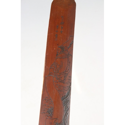 109 - A collection of three oriental bamboo page turners with ornate carved decoration.