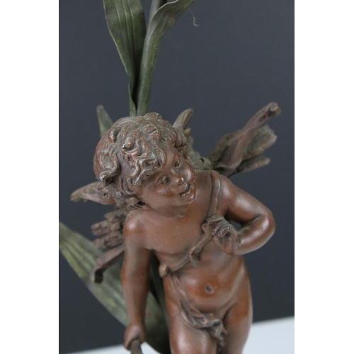 89 - An early 20th century cast lamp in the form of a flower and cherub.