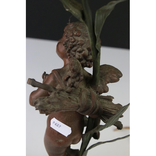 89 - An early 20th century cast lamp in the form of a flower and cherub.