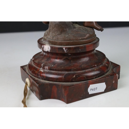 89 - An early 20th century cast lamp in the form of a flower and cherub.
